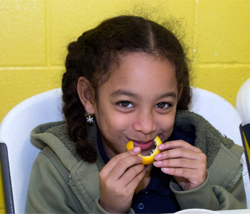 Girl eating an orange slice