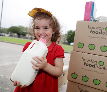 Girl smiling holding milk carton